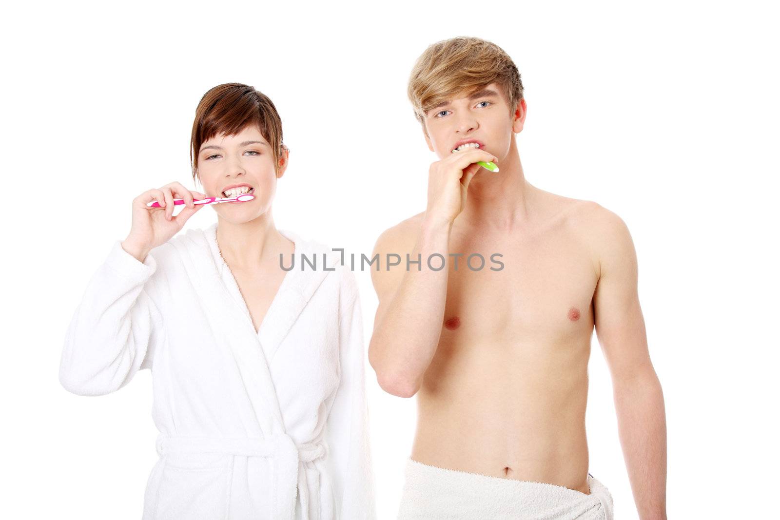 Young couple cleaning teeth together. Isolated on white