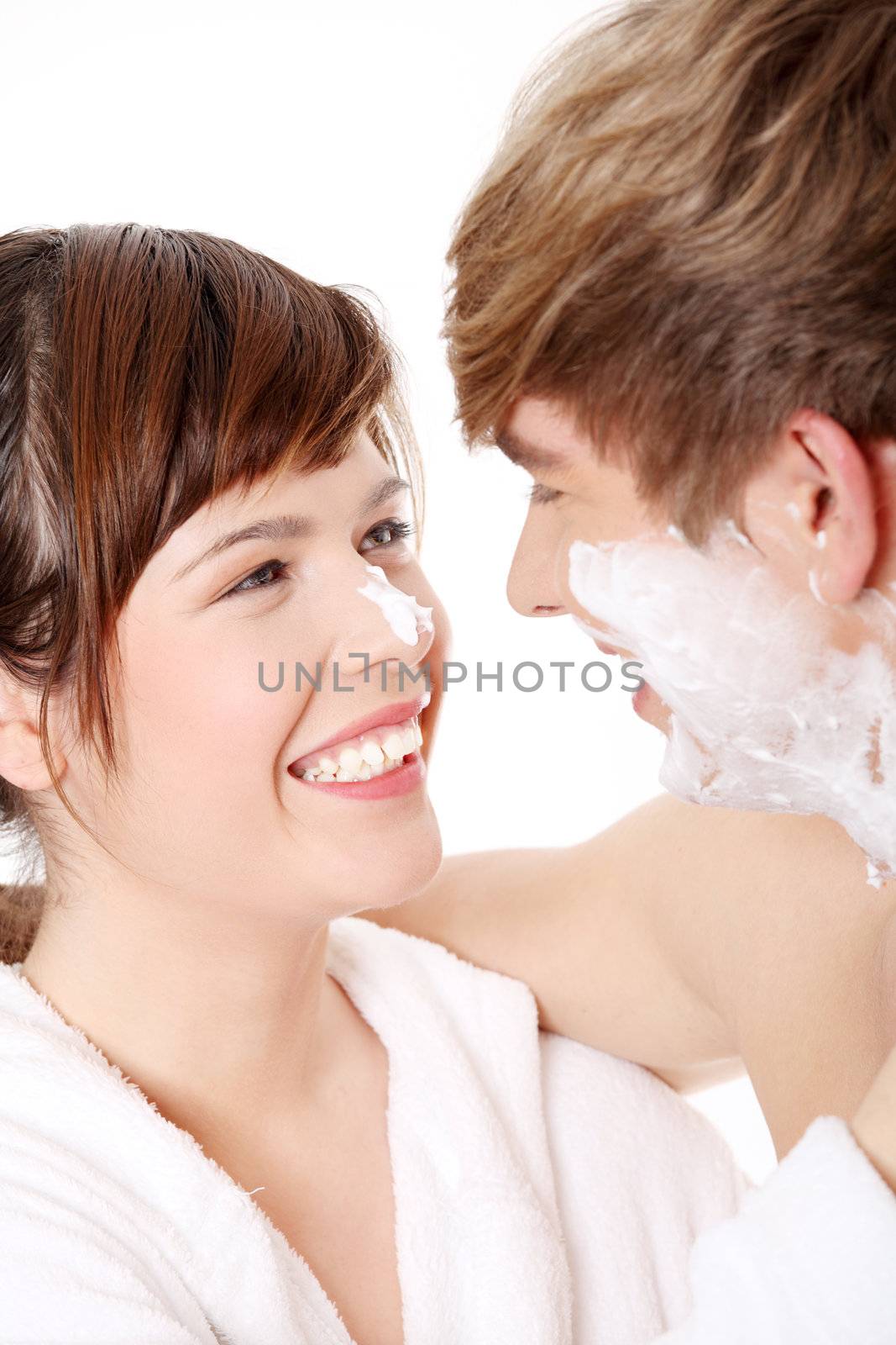 Young couple at bathroom. Isolated on white.