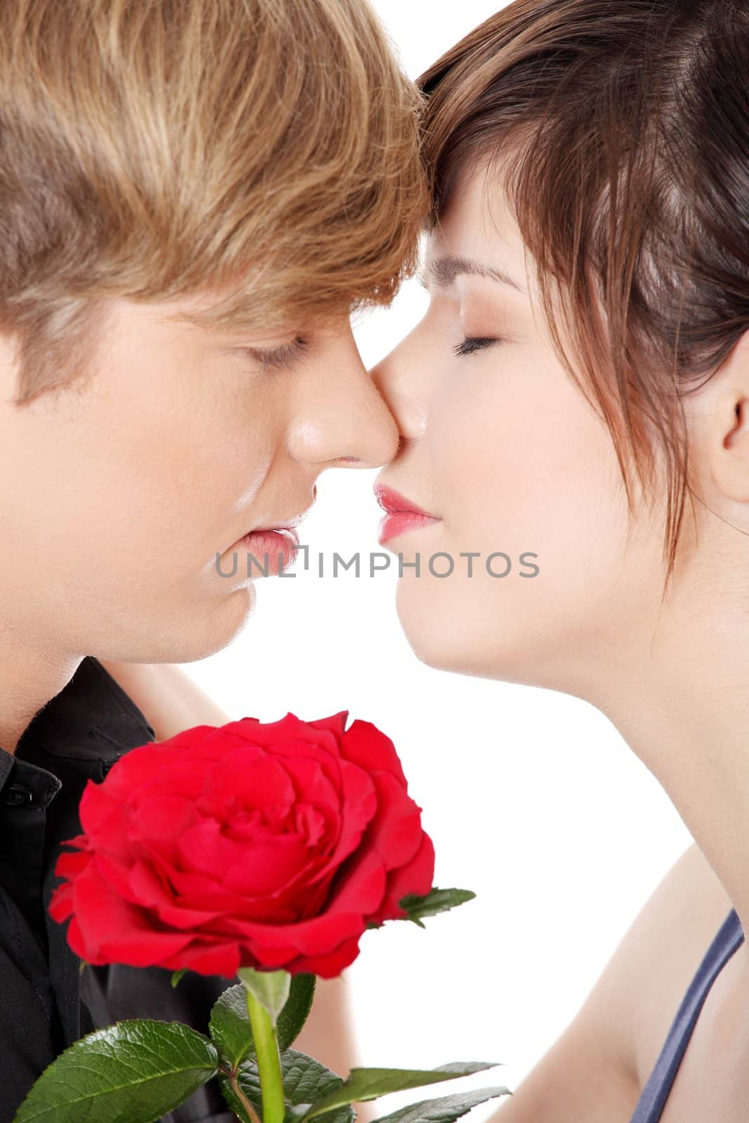 Kissing young couple. Isolated won white background.
