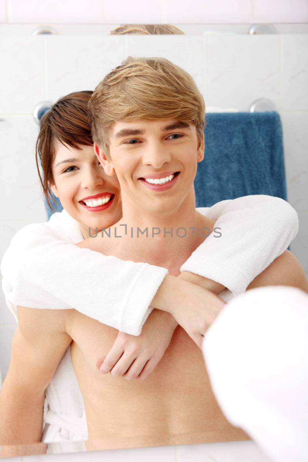 Young happy couple at bathroom. Isolated on white.