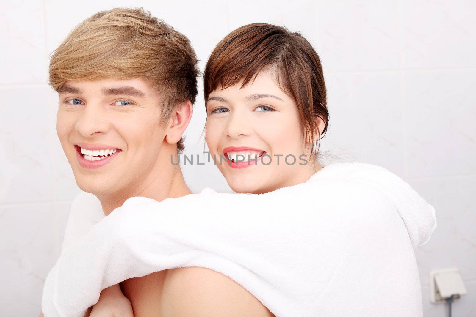Young couple at bathroom. Isolated on white.