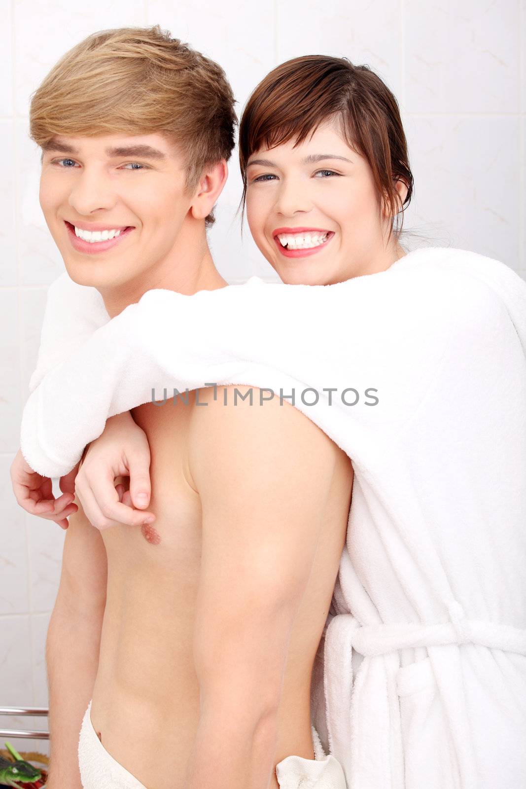 Young happy couple at bathroom. Isolated on white.