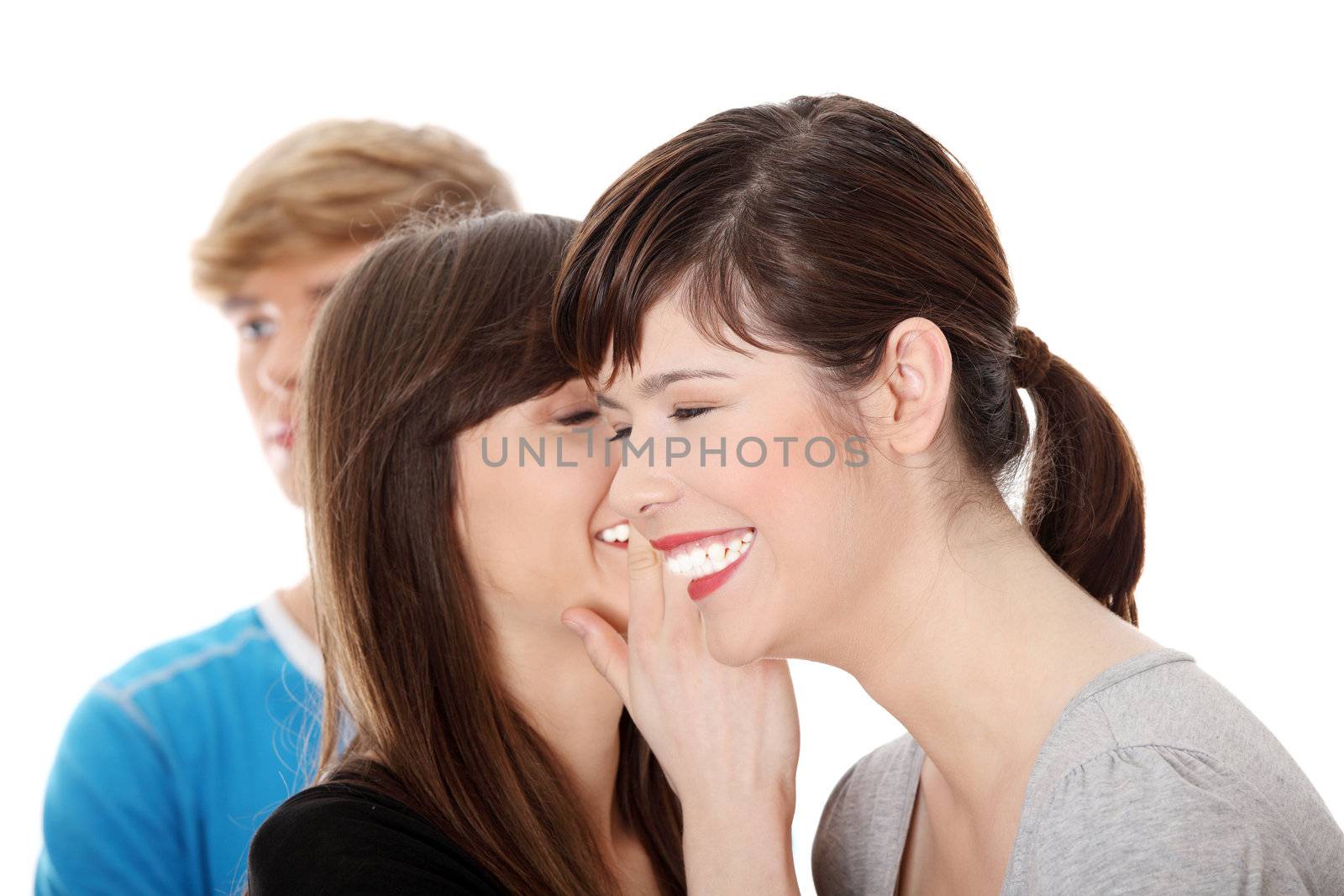 Two girls talking (gossip) about boy, isolated on white