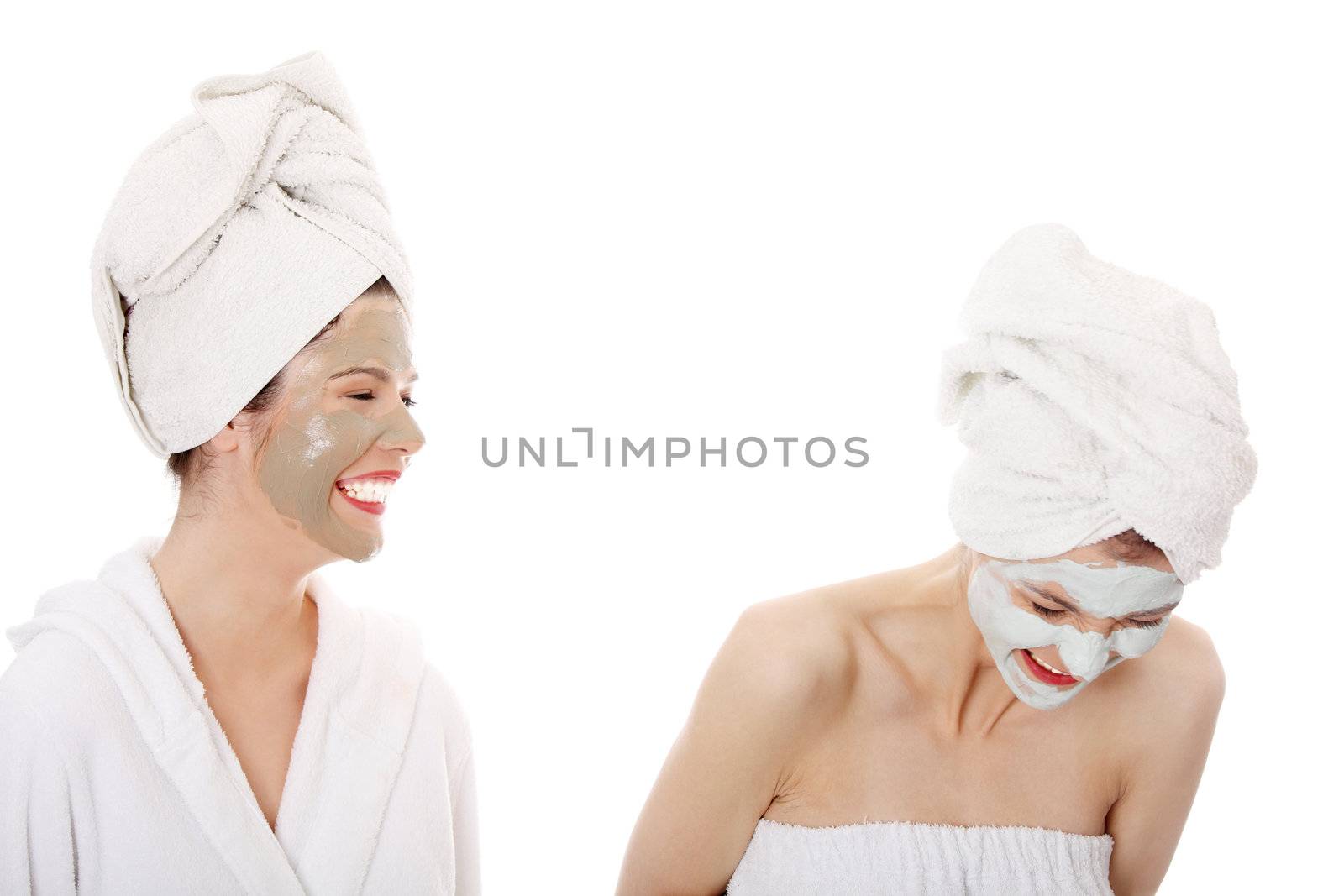 Young happy women with facial clay mask , isolated on white