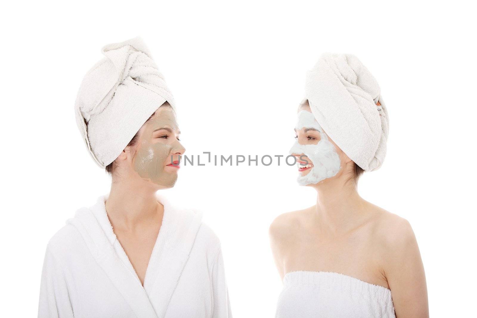Happy two young woman with anti-aging masks . Isolated on white background.