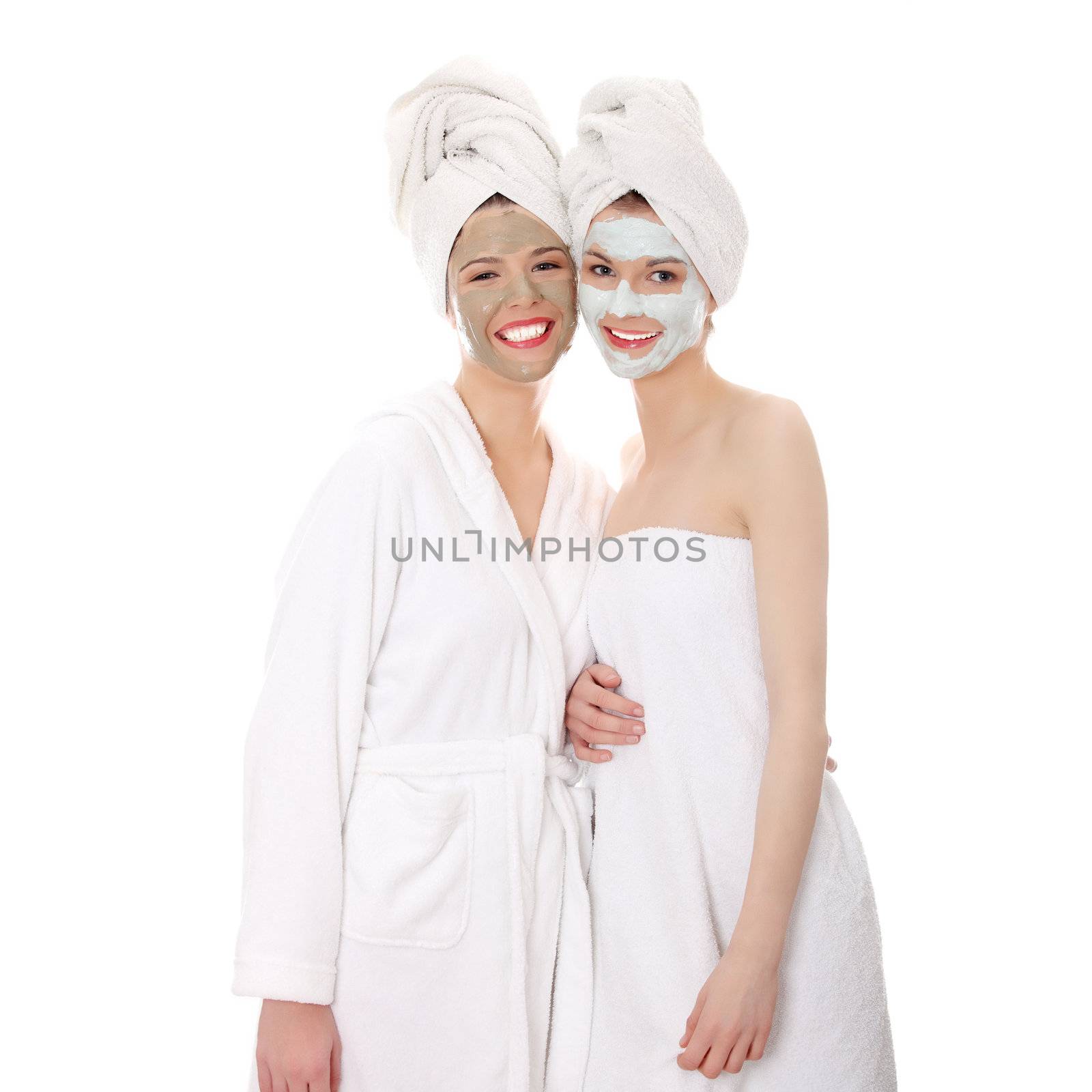 Young happy women with facial clay mask by BDS