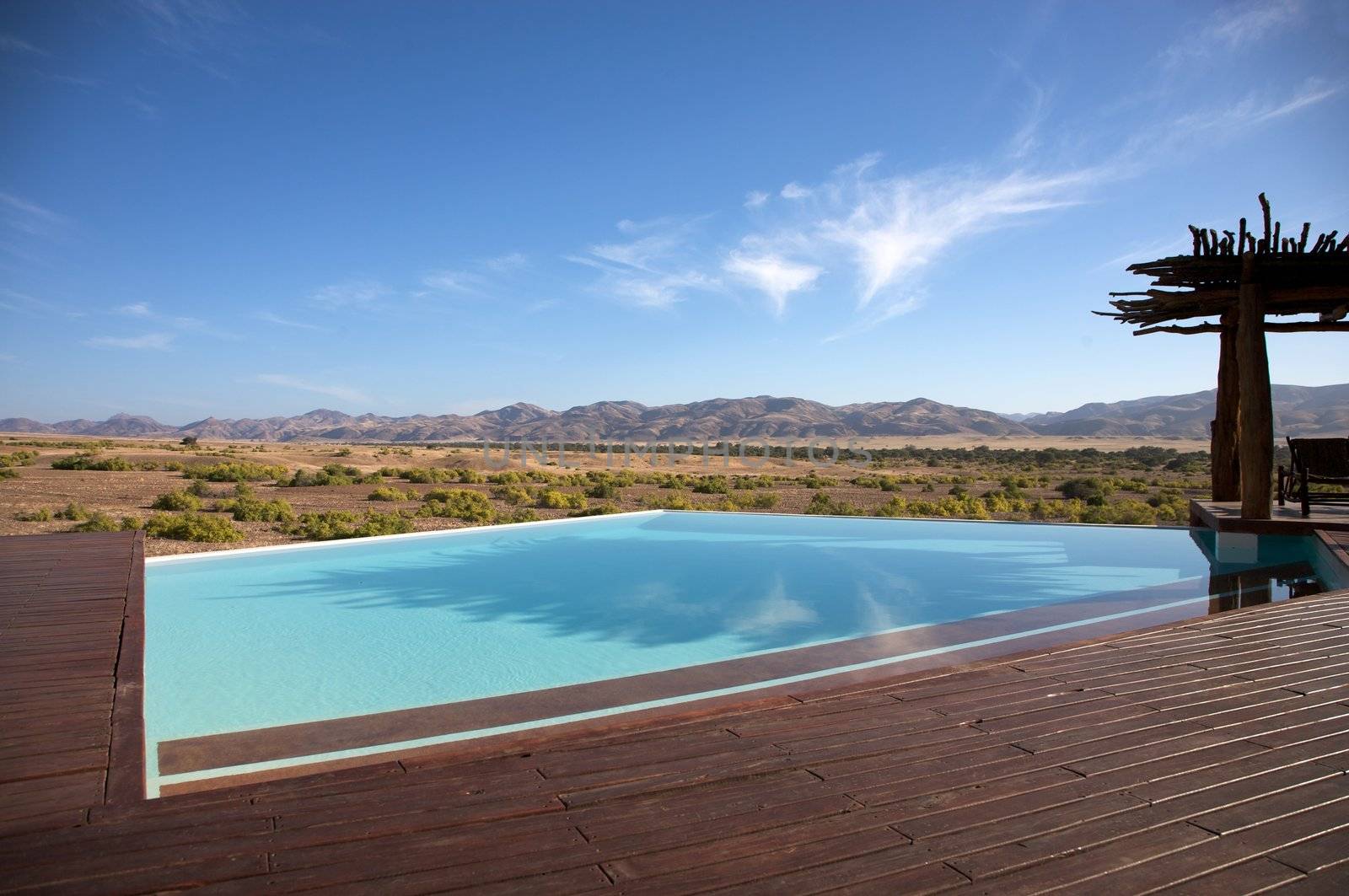 Luxury pool in a hotel and the desert of Namibia by watchtheworld