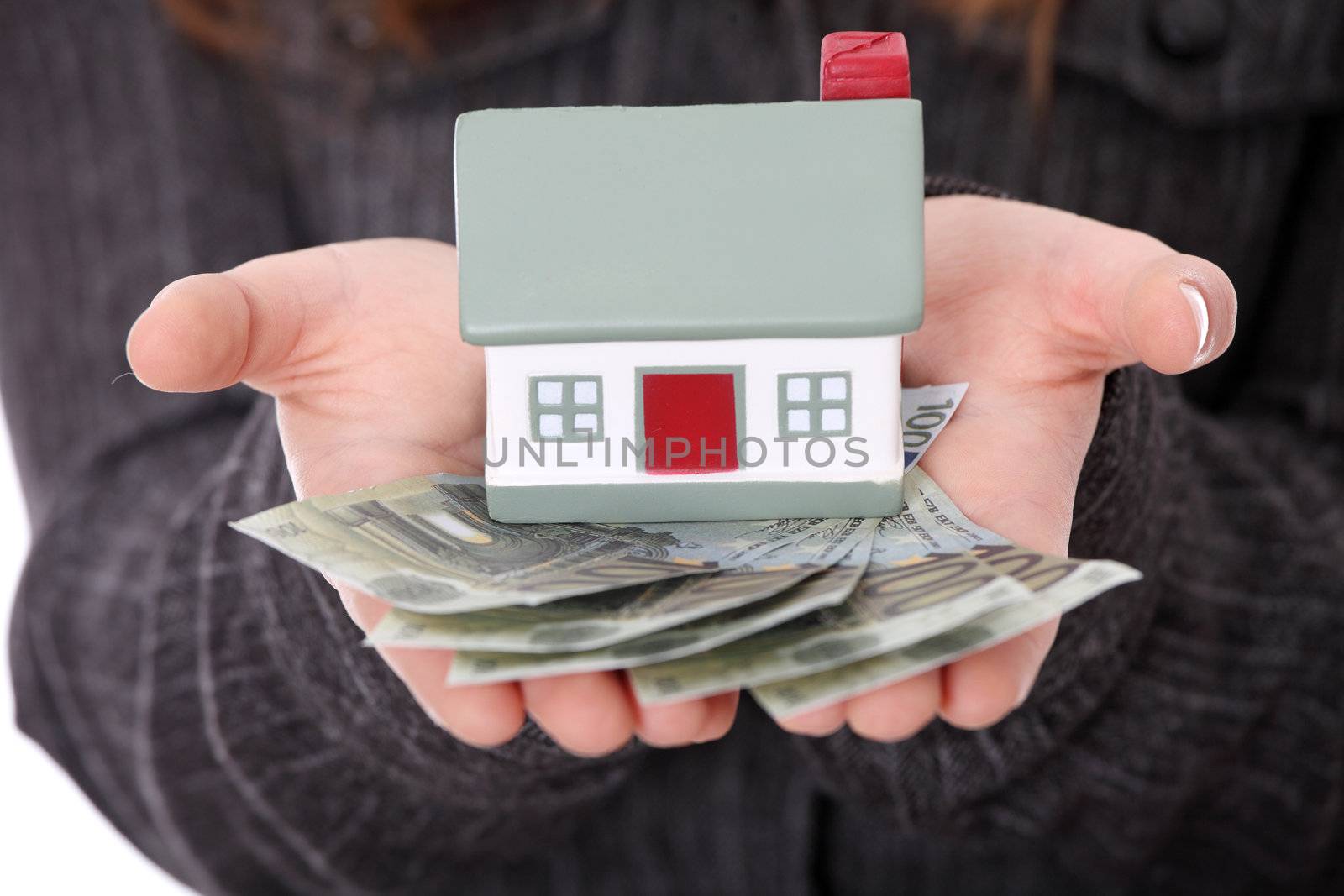 Beautiful young businesswoman holding euros bills and house model over white - real estate loan concept