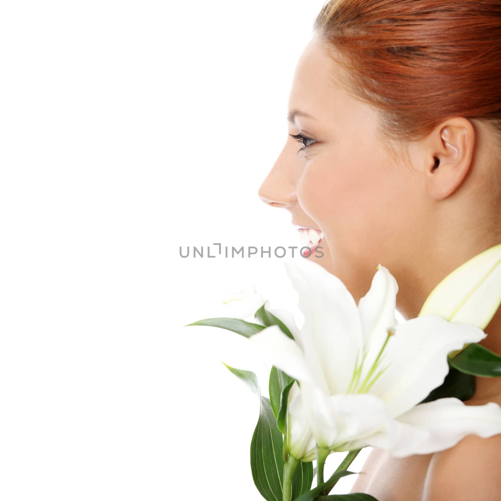 Portrait of the attractive girl with lily flower in hand, isolated on white background