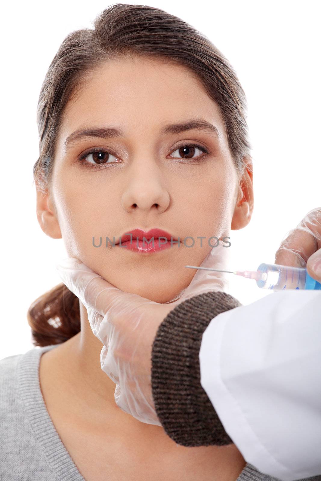 Plastic surgeons giving botox injection in female skin. Isolated on white