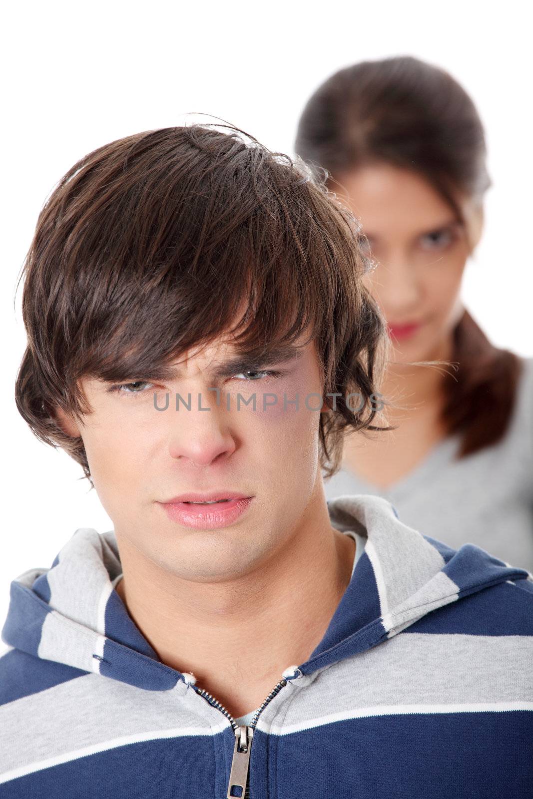 Young beaten up caucasian man standing in front of angry young woman. Couple fight. Isolated on white
