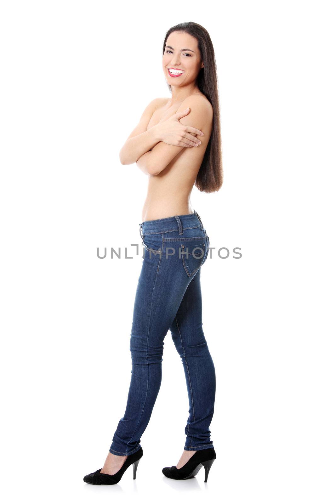 Young topless woman with long hairs, dressed in jeans. Isolated on white