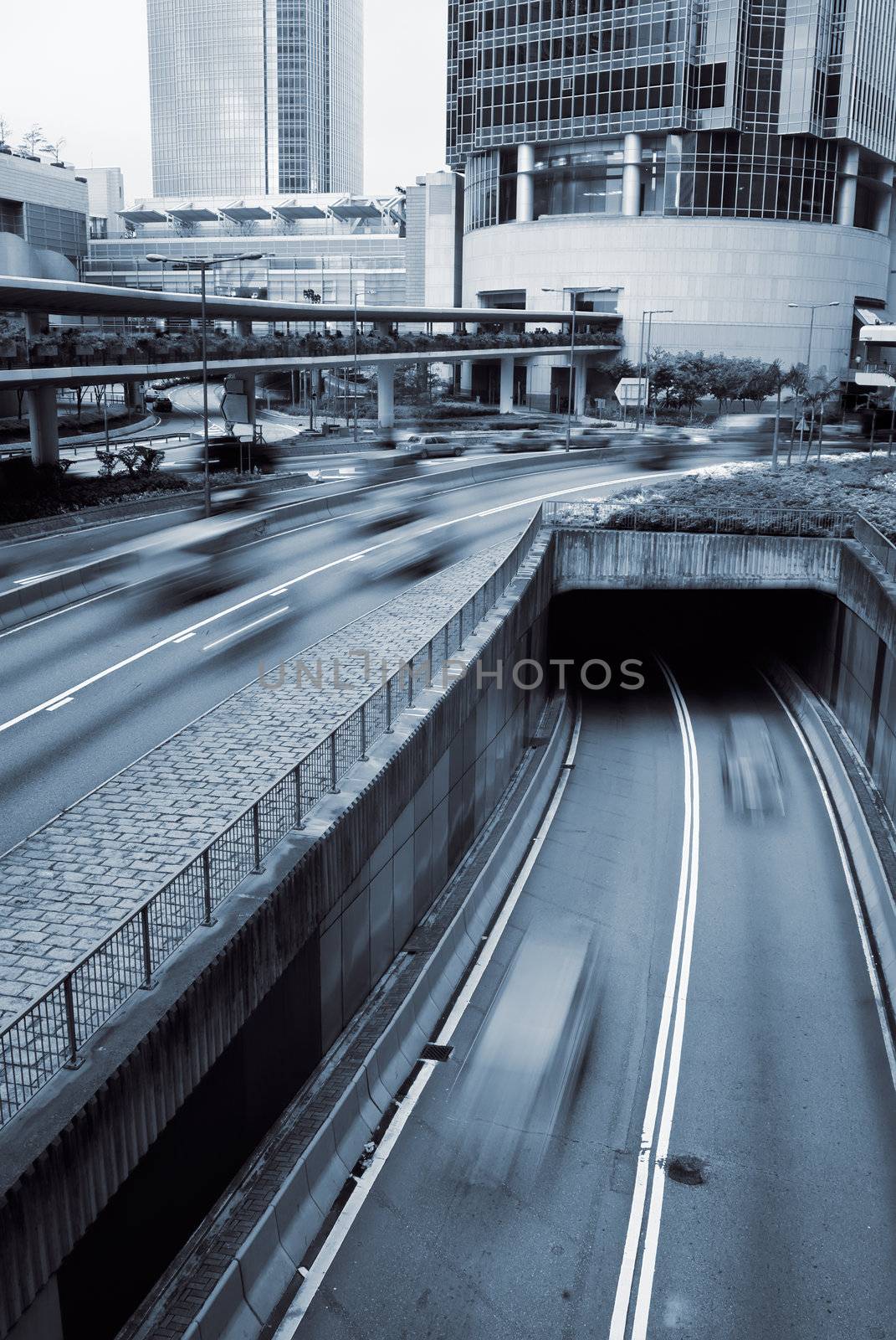 Modern city scenery with cars motion blurred on road in Hong Kong.