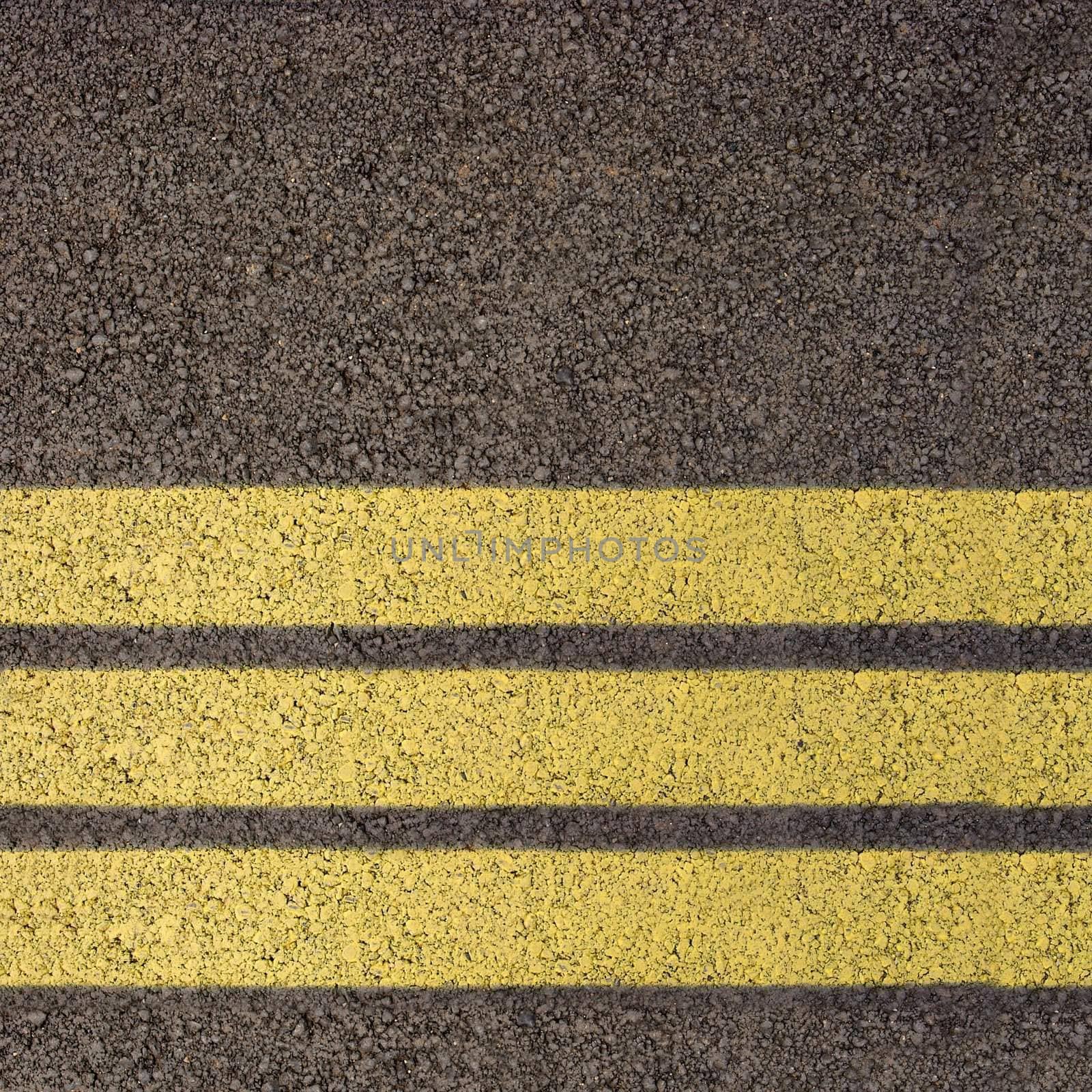 Asphalt texture with three yellow lines