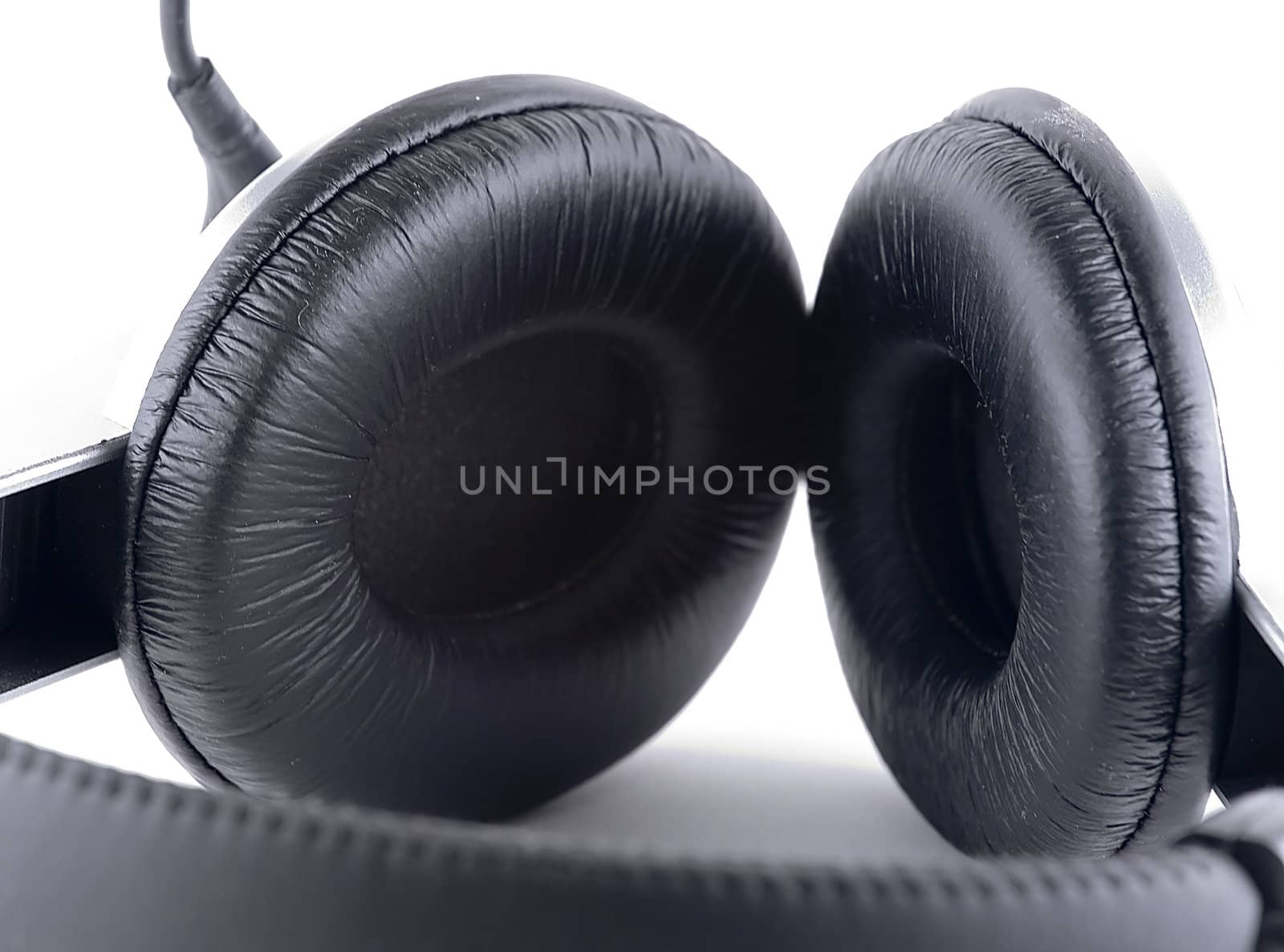 Black headphones over white background