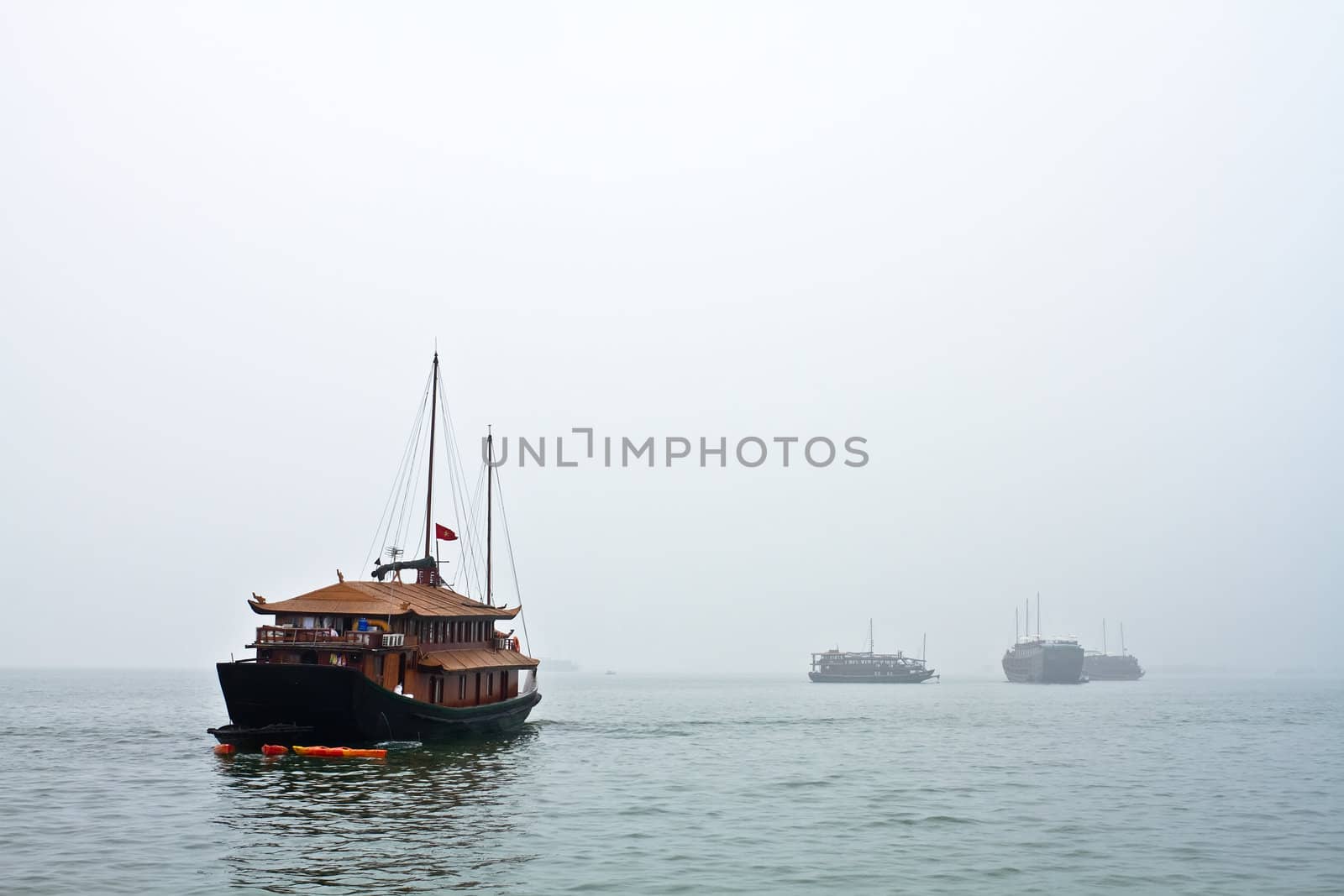 Boats head off to work in a windy cloudy day in Vietnam