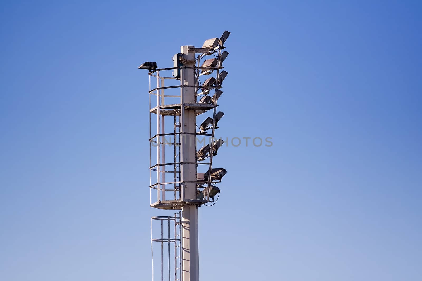 Stadium lights and clear blue sky