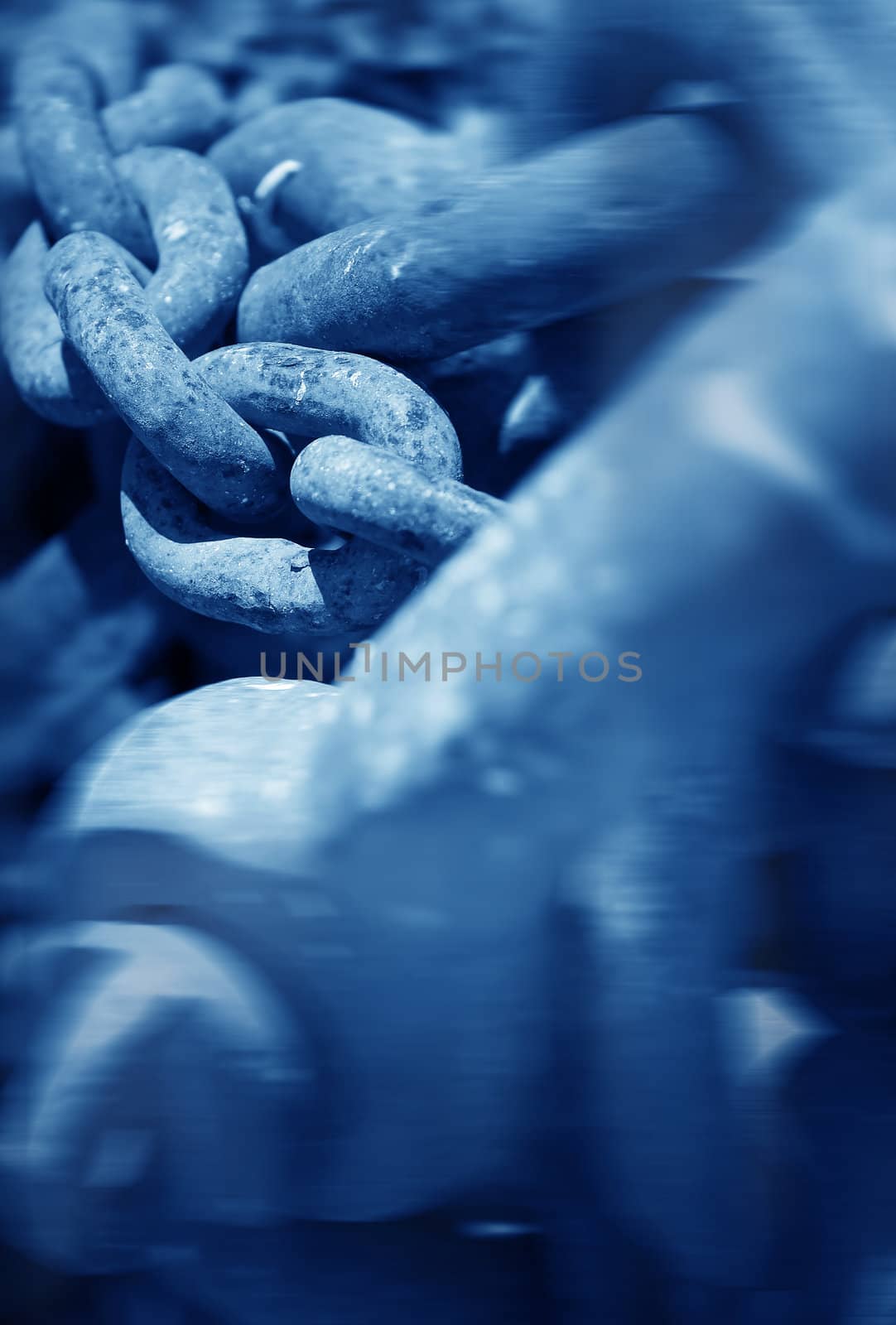 Rusty metal chains at the dock , blue toned conceptual photo with soft focus