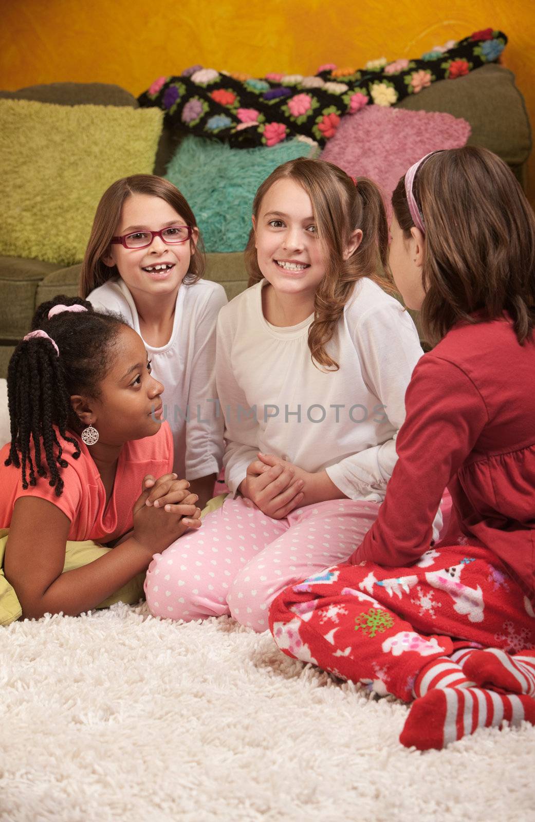 Little girl wrings hands with friends at a sleepover