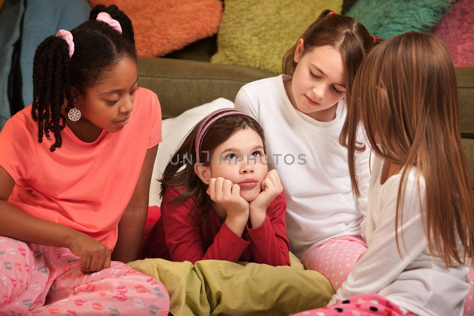 Little girl with hands on chin at a pajama party
