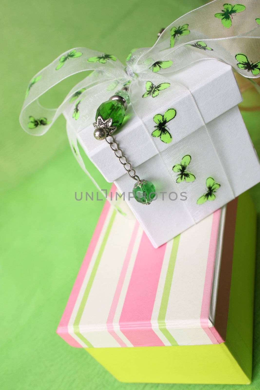 Pink gift box and white box with ribbon and pin