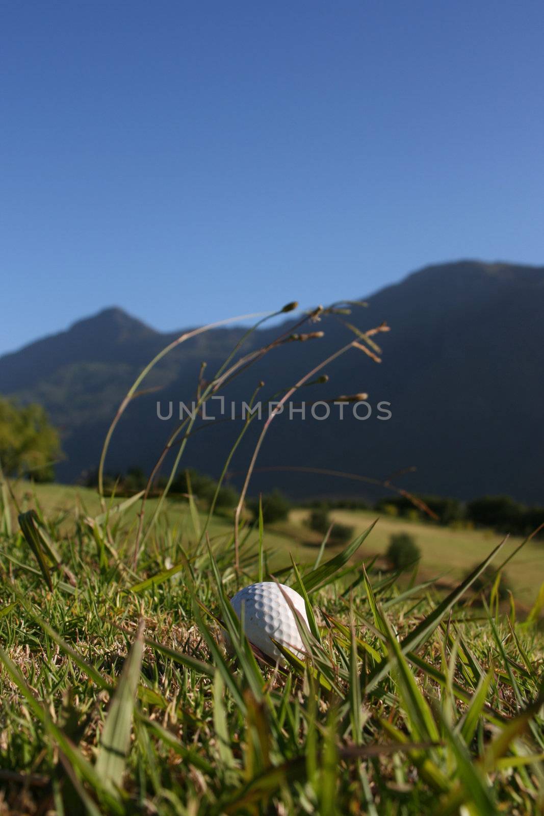Golf Ball on a golf course with a mountain range in the background