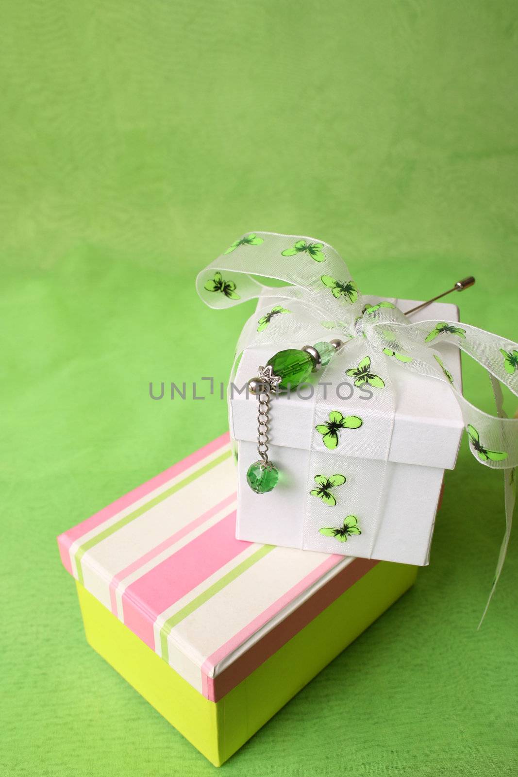 White and striped gift box with ribbons