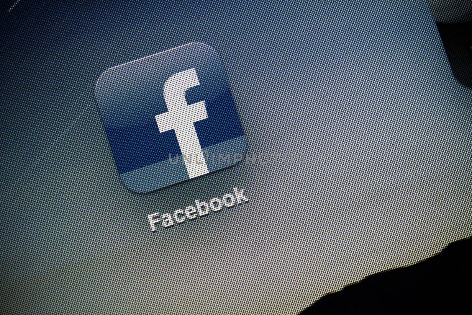 Kiev, Ukraine - October 15, 2011: Macro shot of Facebook logo on the screen of Apple Ipad2. Facebook is largest and most used social network.