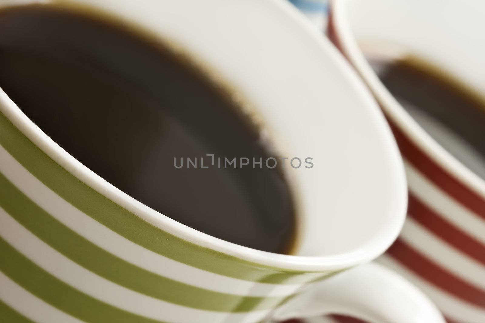 Close ups of mugs of black coffee by tish1