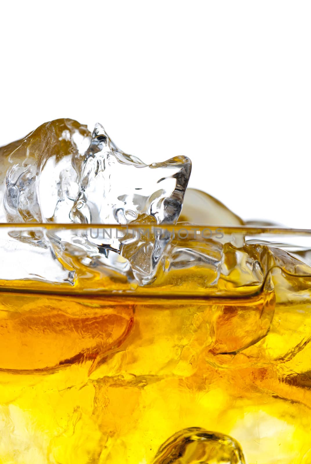 Close up of whiskey on the rocks isolated on white