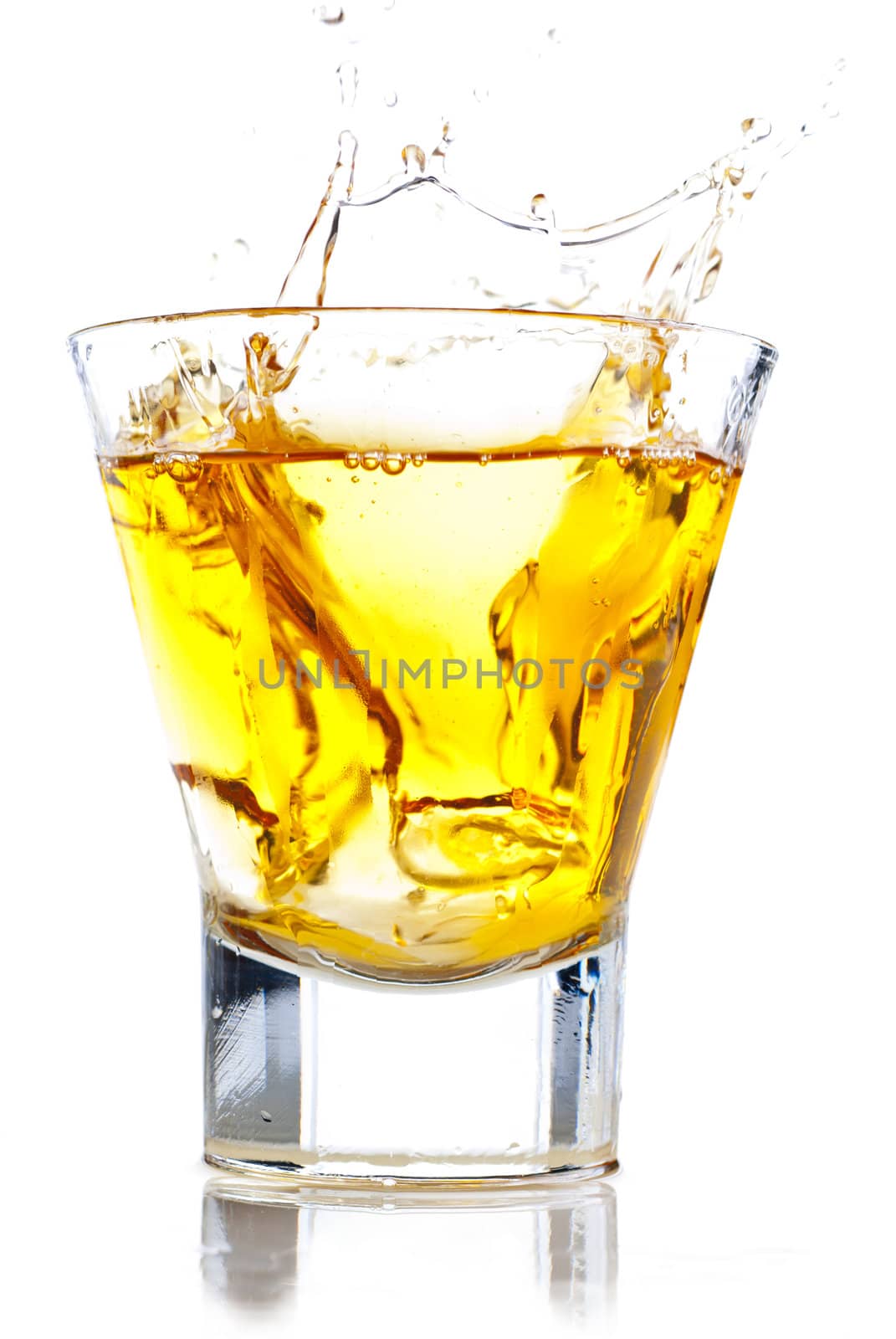 Splash of whiskey on the rocks isolated on white