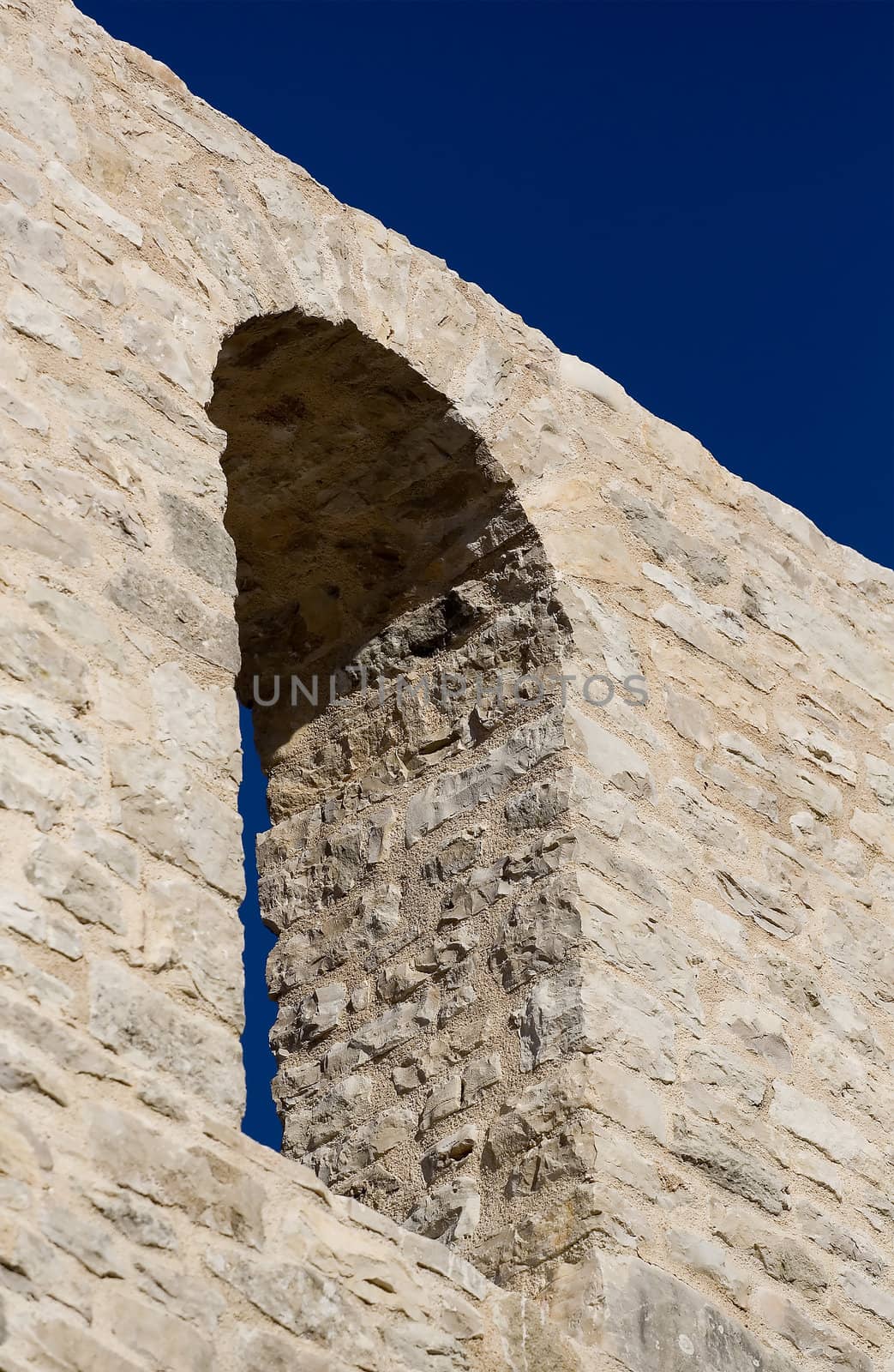 Window on the old stone wall