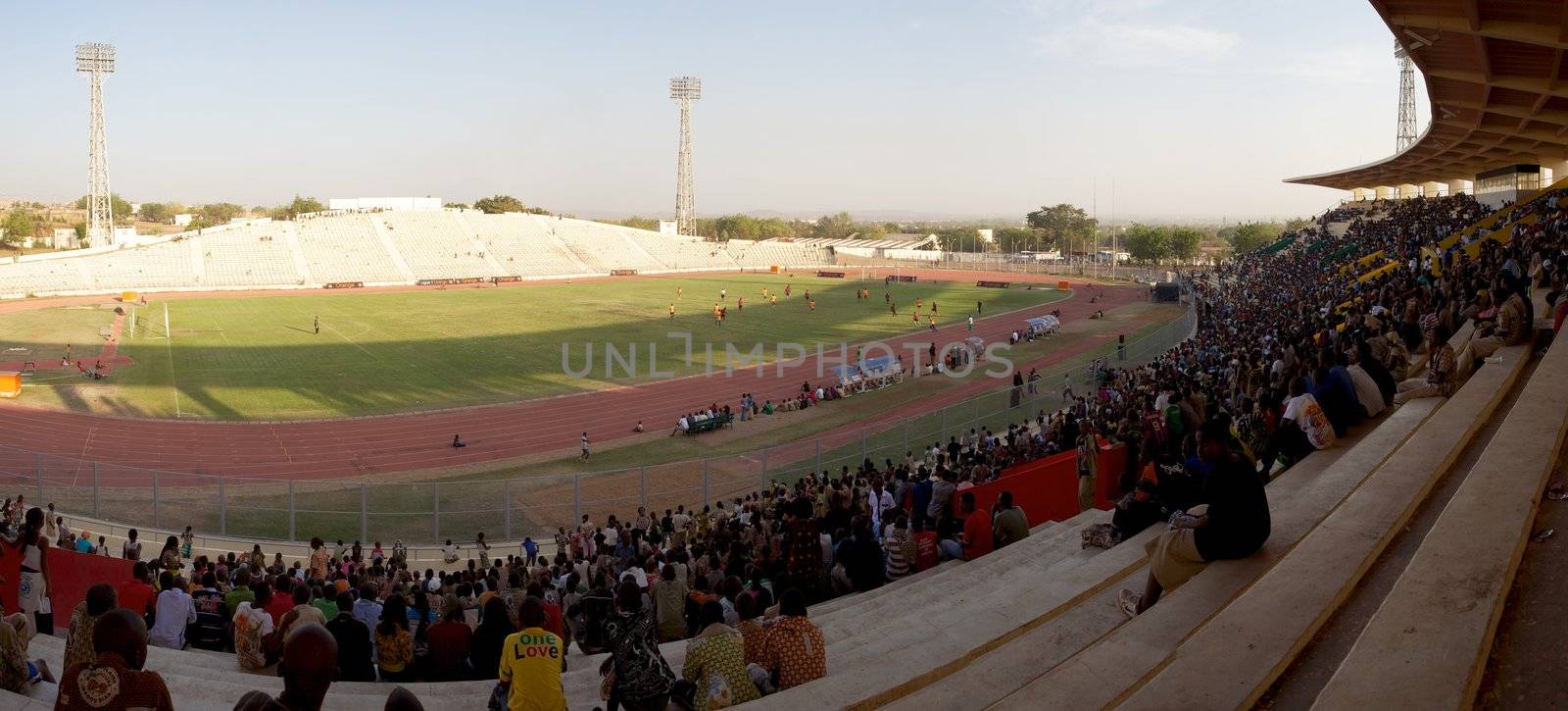Shot from above a crowd watching a football game into the stadium of Bamako in Mali.