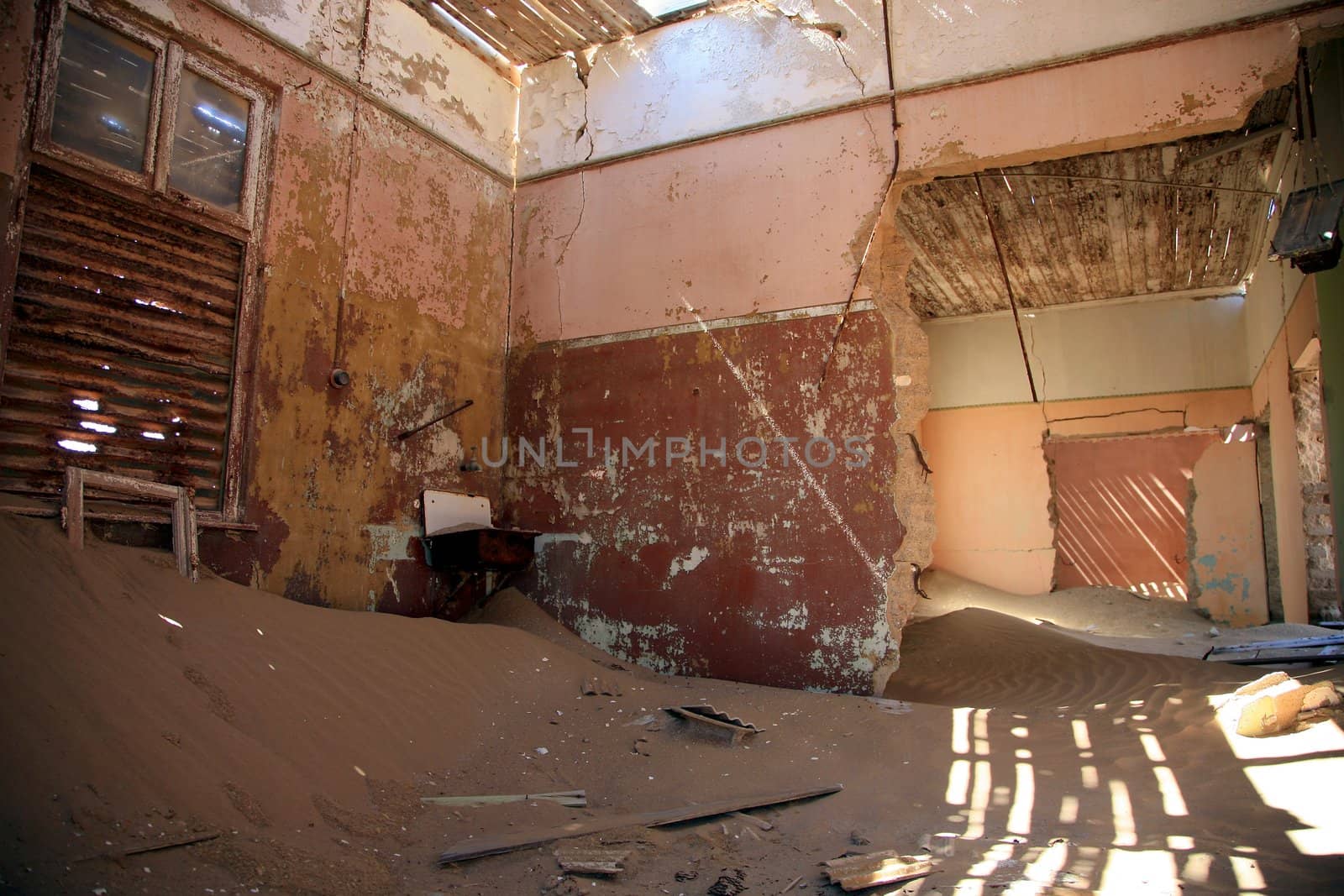 A small sand dune formed in an old derelict house in Kolmanskop, Namibia