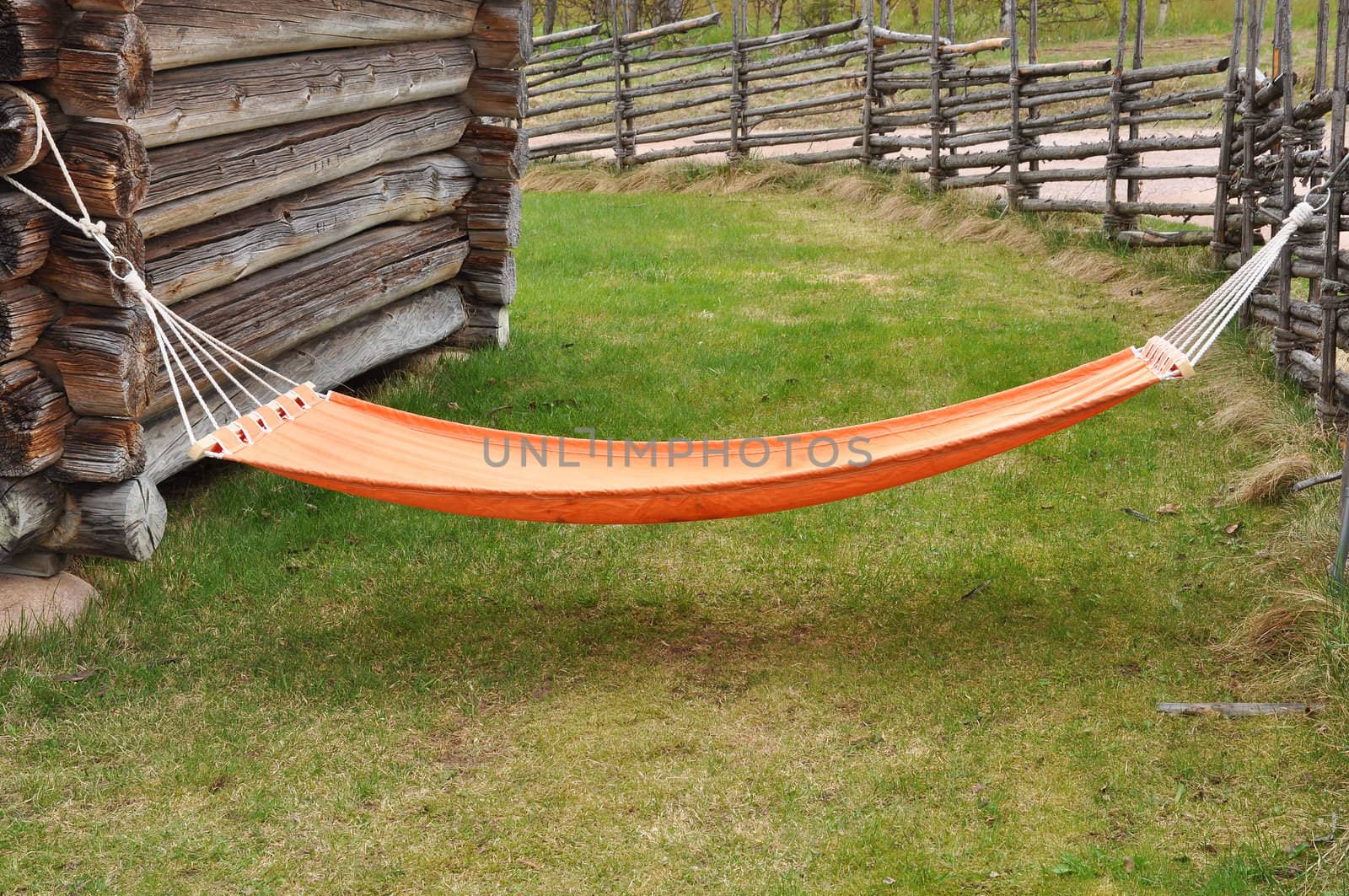 Orange hammock in rural country.