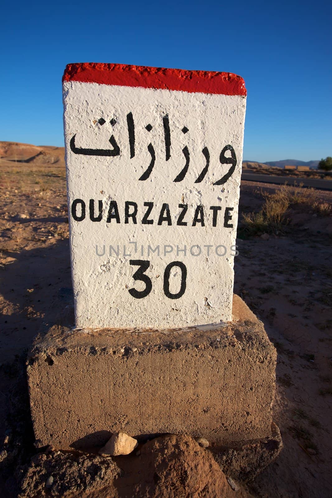 Road Sign to Ouarzazate in Morocco with blue sky