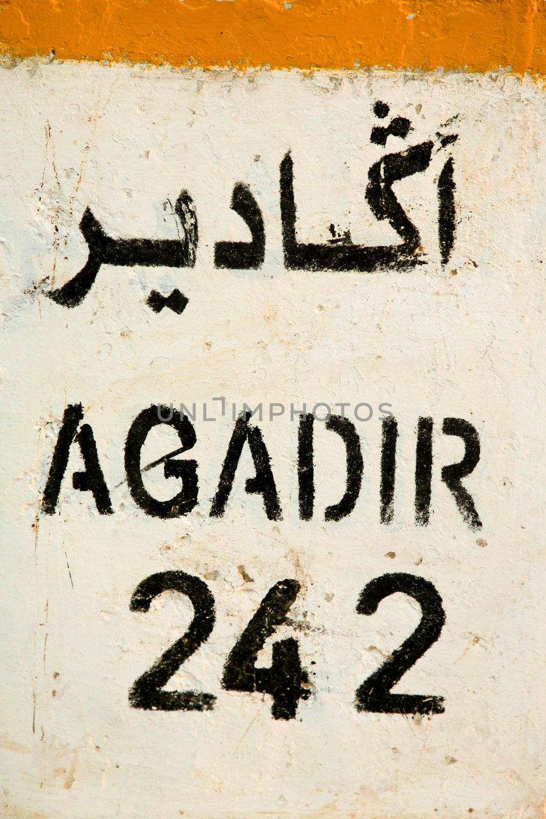 Sign road with the distance left to drive to reach Agadir at 242 km.