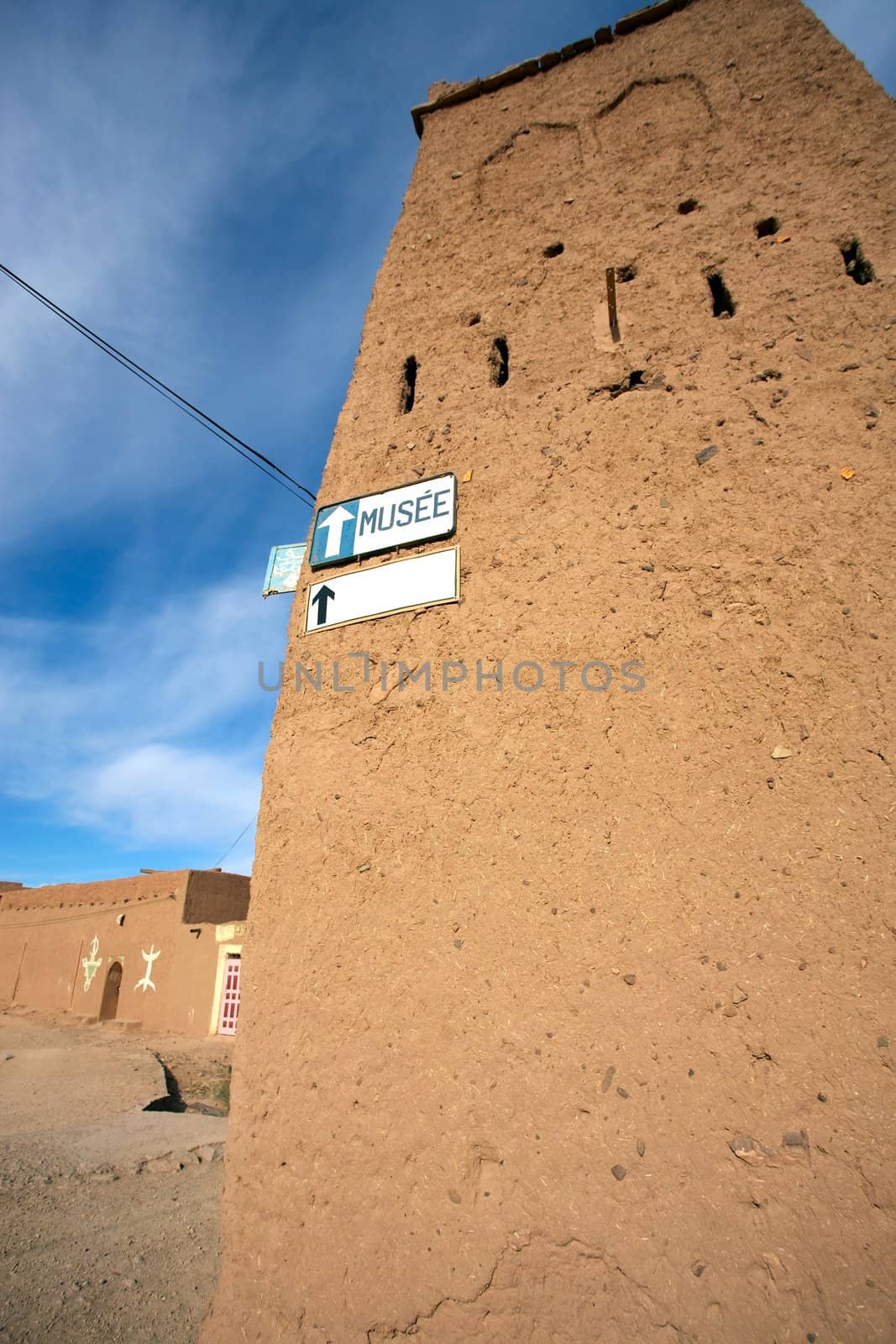 Old Moroccan house with a signboard to the musem with blue sky