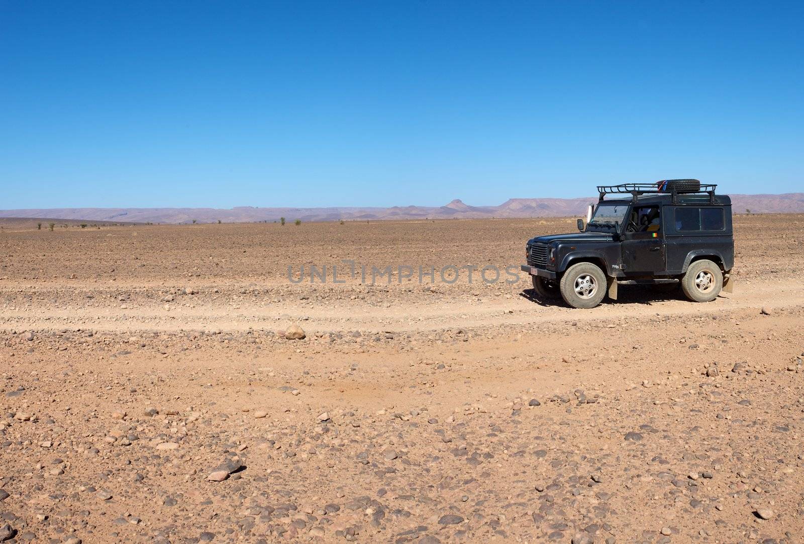 A four wheel drive car on a desert road in Morocco