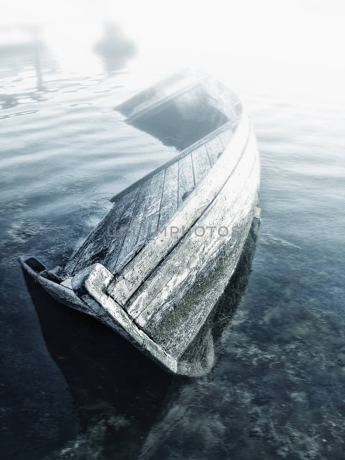 Old abandoned sunken wooden boat in the bay