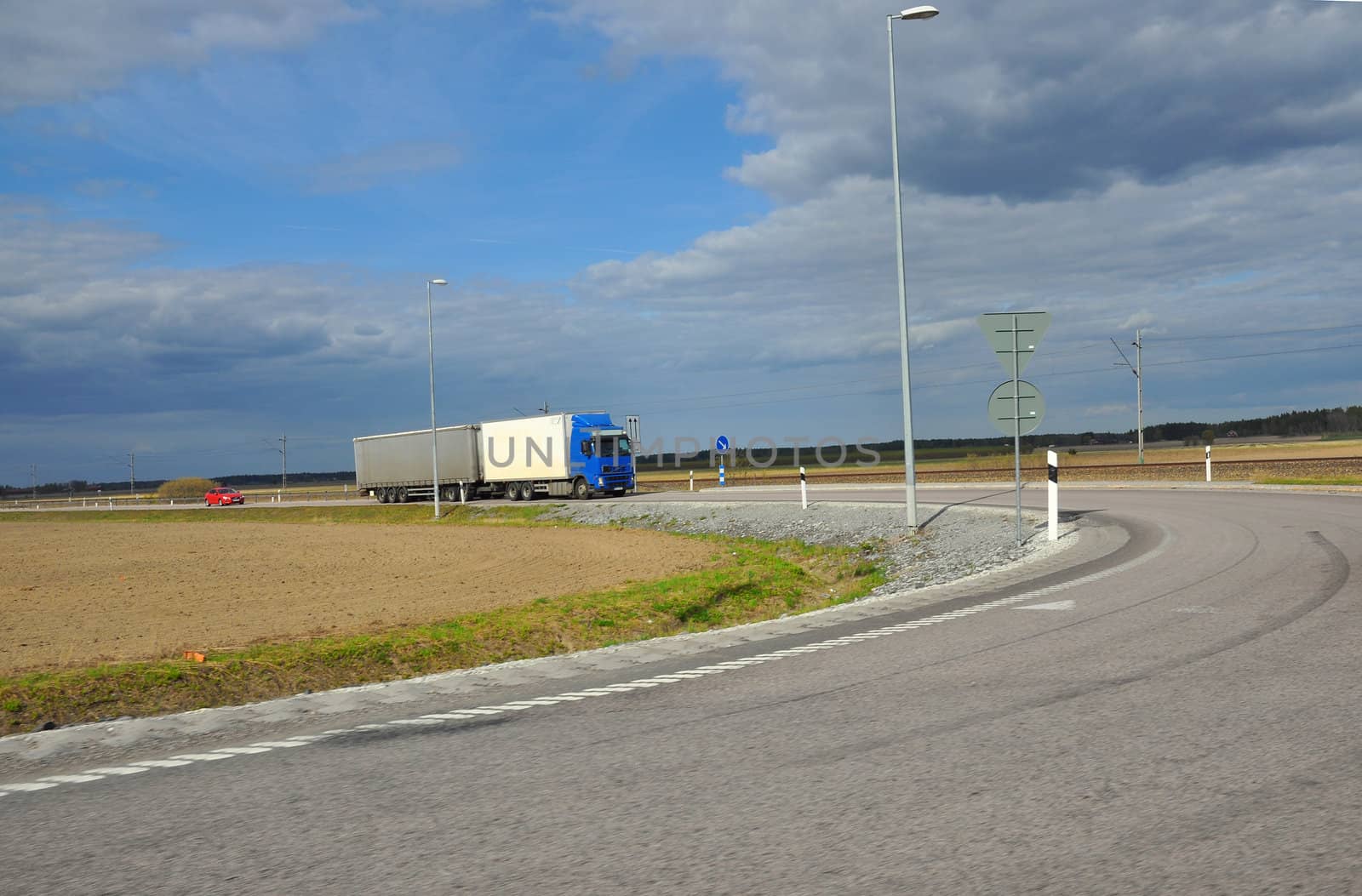 Blue and white truck on the road.