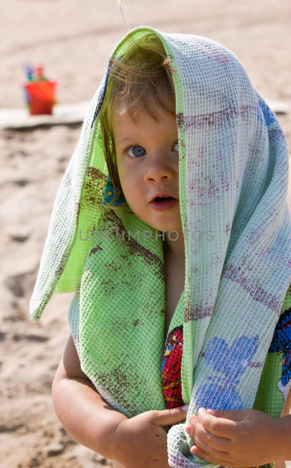 portrait of little girl with green towel