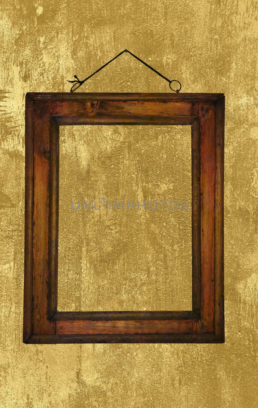 Old wooden frame hanging on a grungy wall.