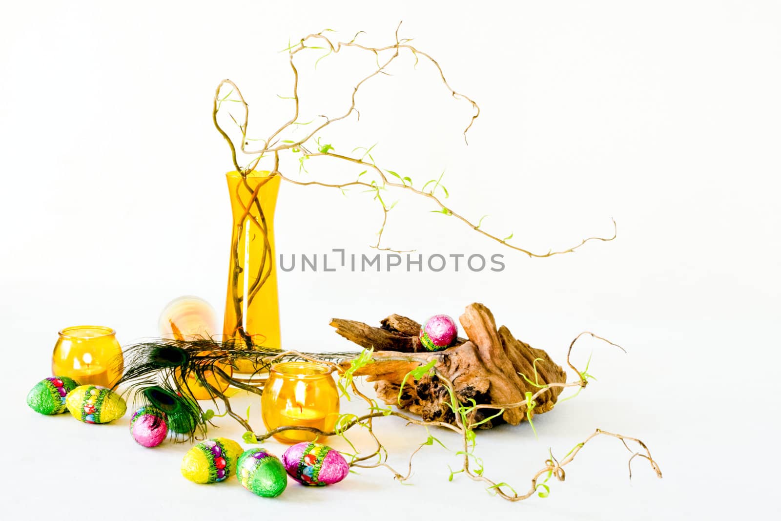 Easter decoration with yellow glass-ware and chocolate eggs