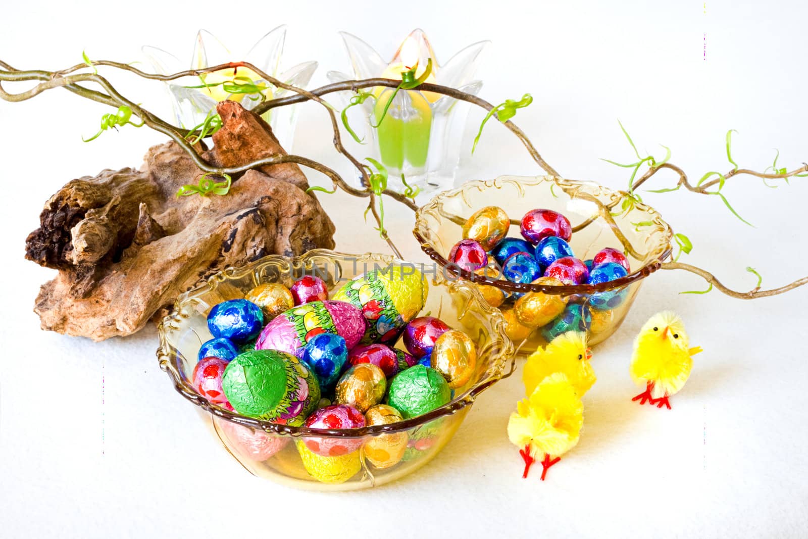 Easter decoration with chocolate eggs in yellow glass bowls