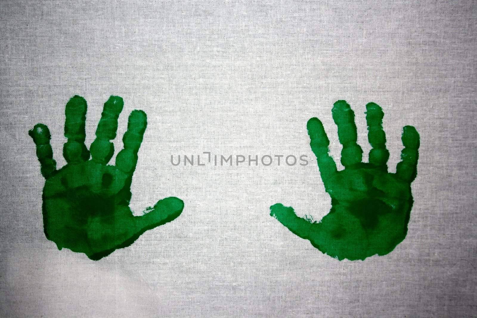 Green handprints on white cotton canvas by sundaune