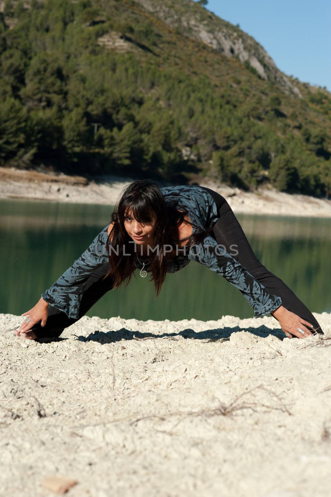 Hispanic woman enjoying early morning yoga exercises in a beautiful natural setting