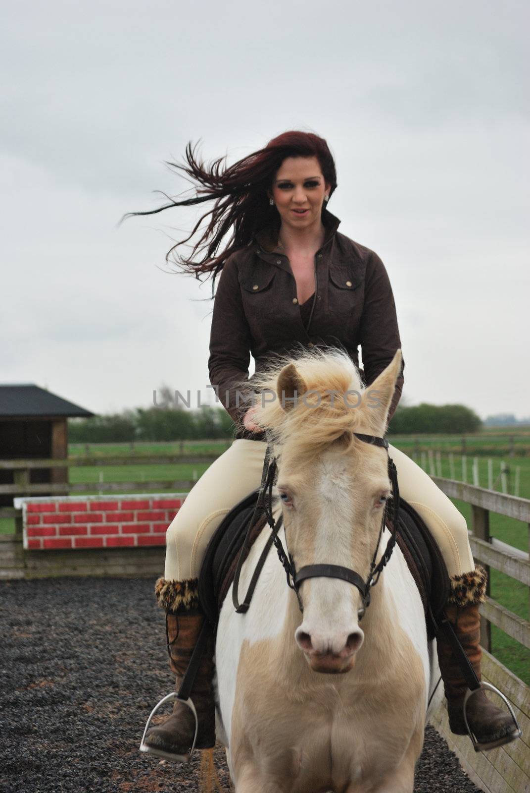 Young girl riding horse