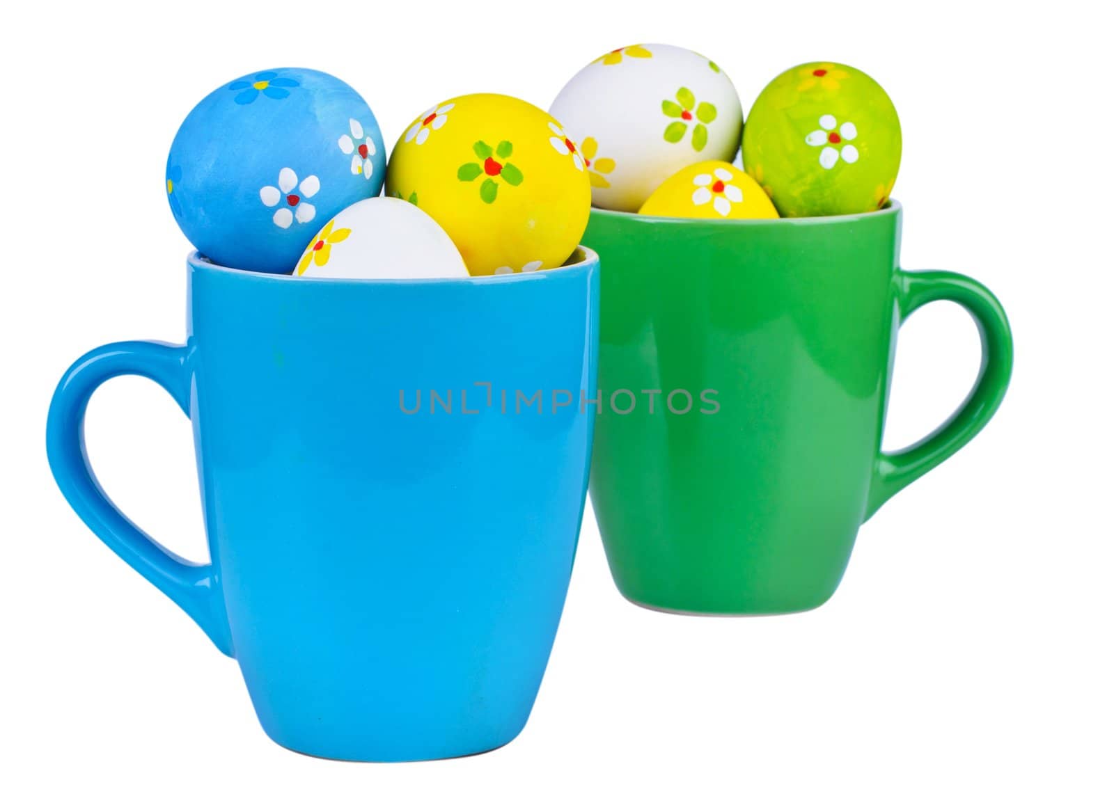 Polka dot easter eggs in cups on white background