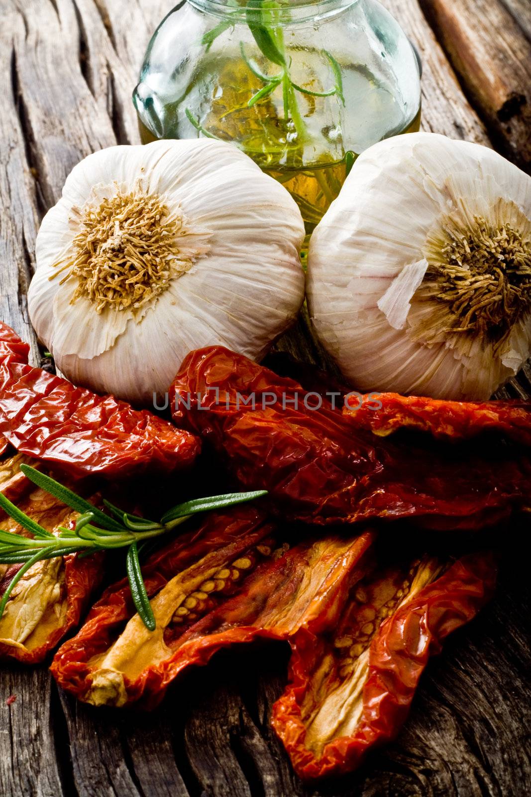 dried red tomato on wood with garlic